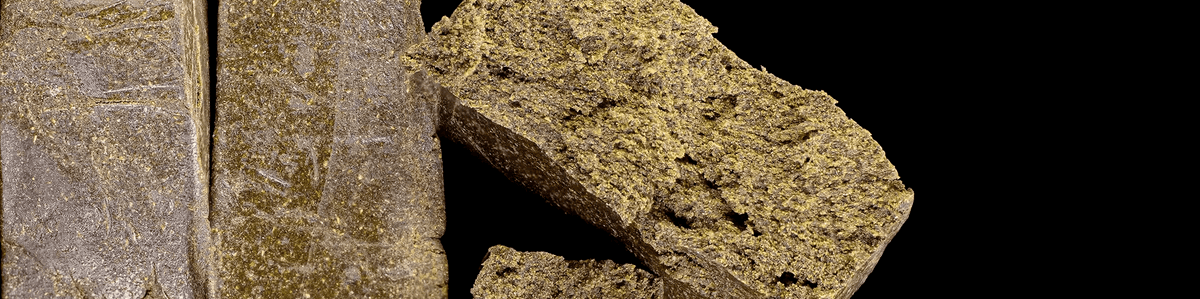 Fine, light-colored hash with a powdery, almost dusty crystalline appearance.