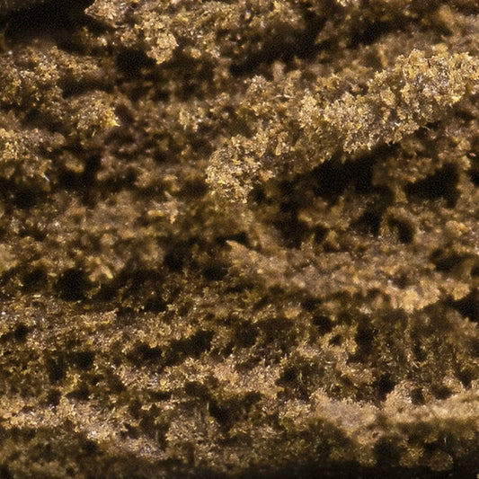 Close-up of Luksus Klump THCA hash showing soft resin texture