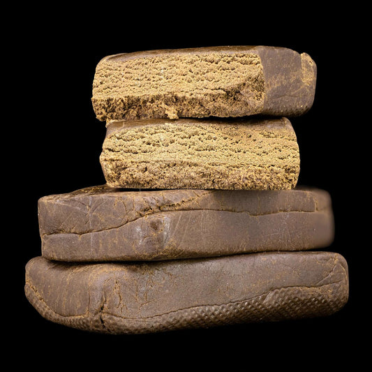Luxus Ketama 25% THCA hash with dark exterior and golden interior