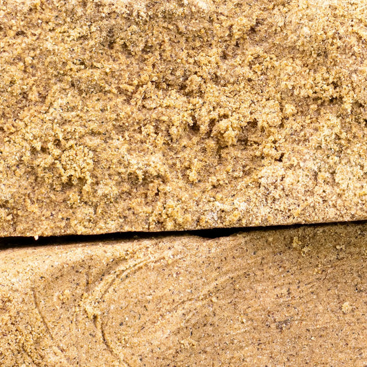 Close-up of La Mousse THCA hash showing compact dry sift structure