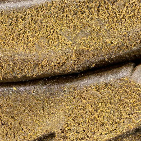 Close-up of Farfar's Favorit THCA hash showing compact structure